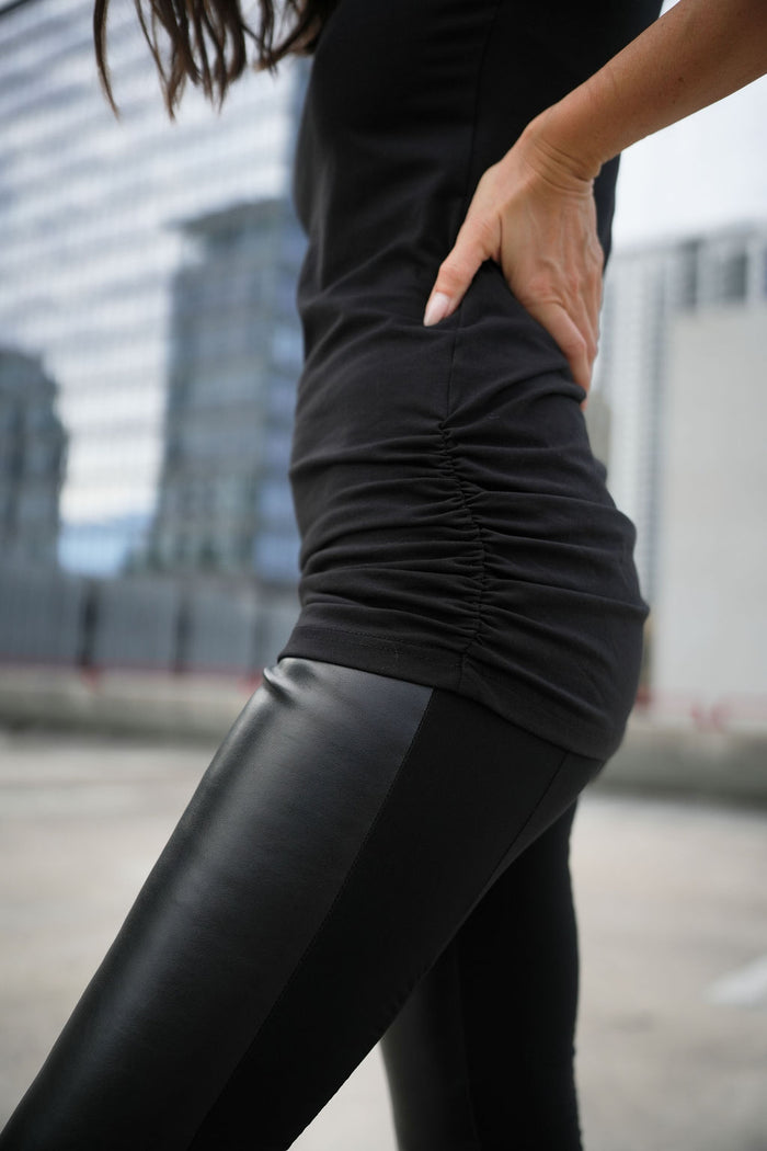 Woman in black lycra cotton ruche tank and black vegan leather leggings on a rooftop in Fort Lauderdale.