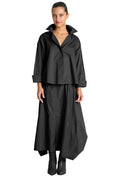 Woman wearing a 100% cotton black outfit on a white background