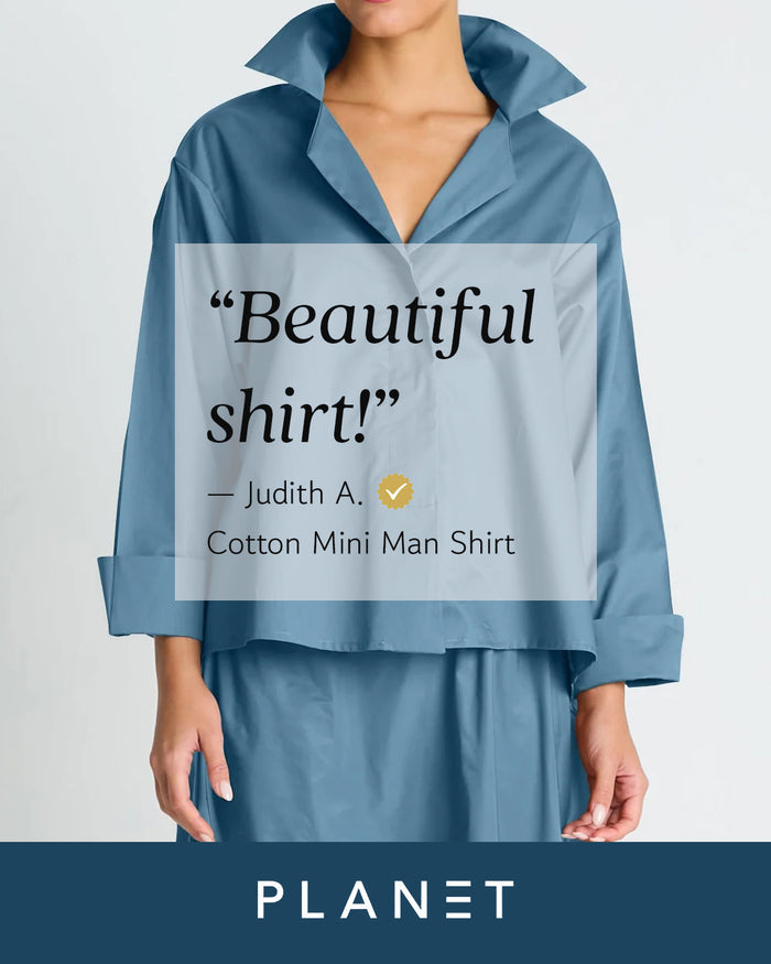 A model wears a blue cotton mini man shirt with a relaxed collar and long sleeves, shown against a light gray background with a text overlay and a dark blue banner at the bottom reading PLANET.