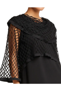 Black netted shawl lined with vegan leather draped over a person on a neutral background