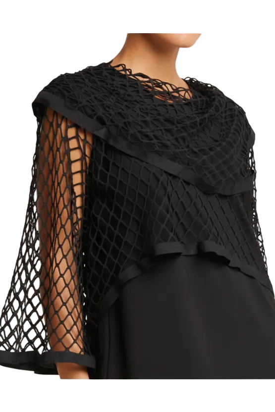 Black netted shawl lined with vegan leather draped over a person on a neutral background