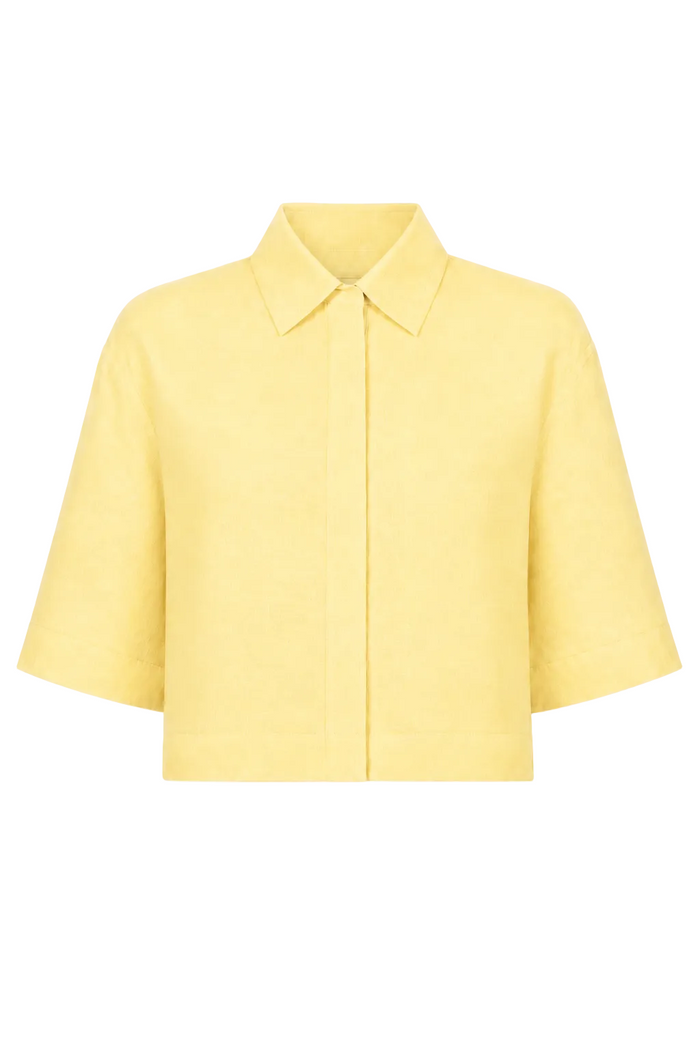 A 100% linen pale yellow cropped short-sleeve collared jacket with a button front, displayed on a clean white background.