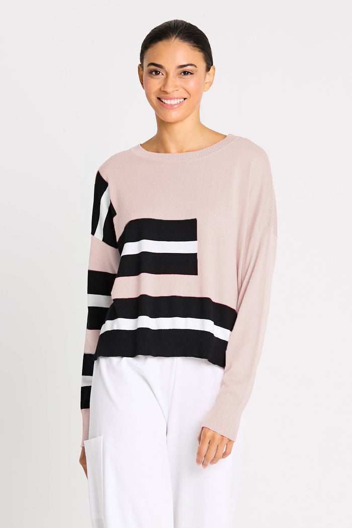 Woman wearing a black and white striped pima cotton top on a white background