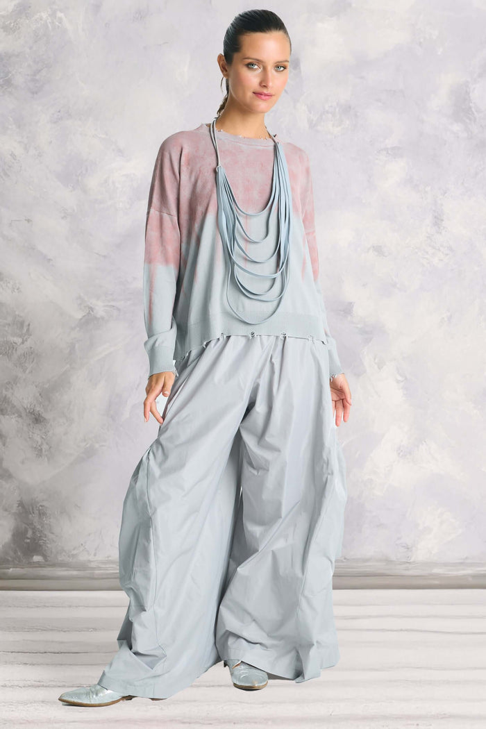 Full-body view of model wearing Planet by Lauren G’s Pima Cotton Bled Out Tattered Crewneck Sweater in ombré pink and blue – lightweight artisanal knit for women.