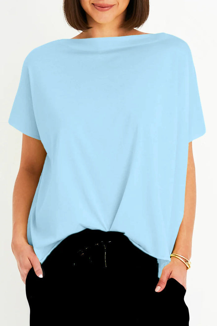 Woman wearing a light blue oversized t-shirt against a white background