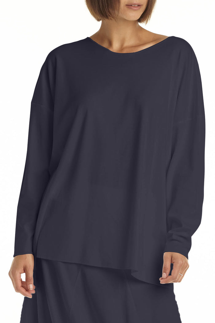 Navy blue long-sleeve top worn by a person on a white background