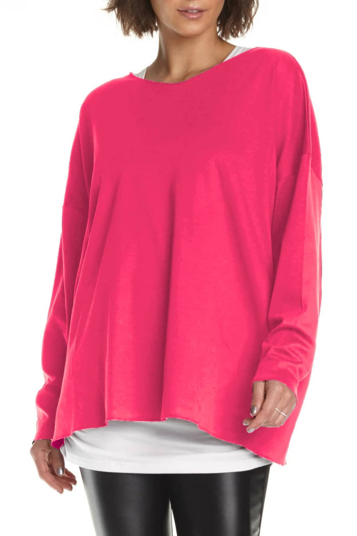 Person wearing a bright pink long-sleeve Pima Cotton top on a white background