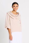 Woman wearing a beige draped pima cotton jackie o tee against a white background