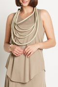 A woman wearing a beige fawn Pima cotton shirttail tank top with an avant-garde neckline.