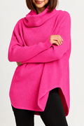 Person wearing a bright pink pima cotton sweater against a white background